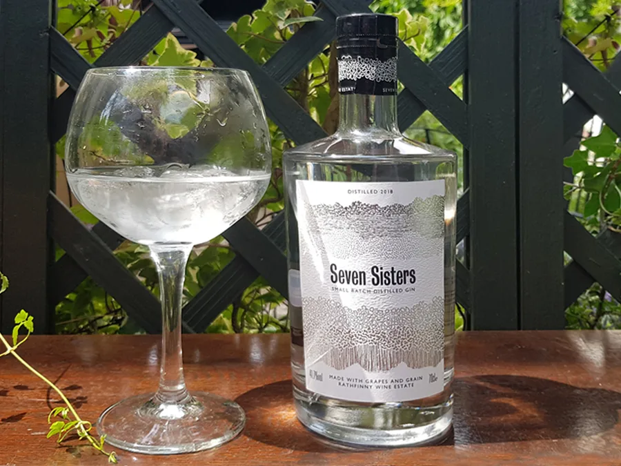 A bottle and glass of Seven Sisters Gin sparking i the sunlight - the perfect Sussex Gin