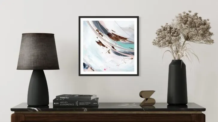 Framed abstract hand embellished print on a wall with turquoise, blue, grey and black colouring