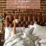 Best hotels in Brighton. Arm reaching up from under the bed covers holding a mug of coffee