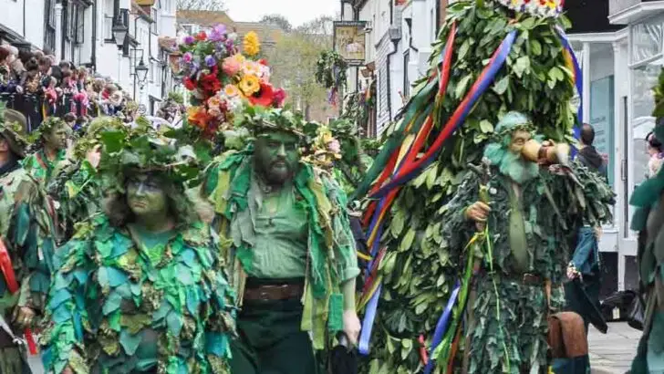 Jack in the Green Hastings. Parade of people dressed in green foliage costumes with Jack a towering costume with a crown on top to symbolise the start of summer