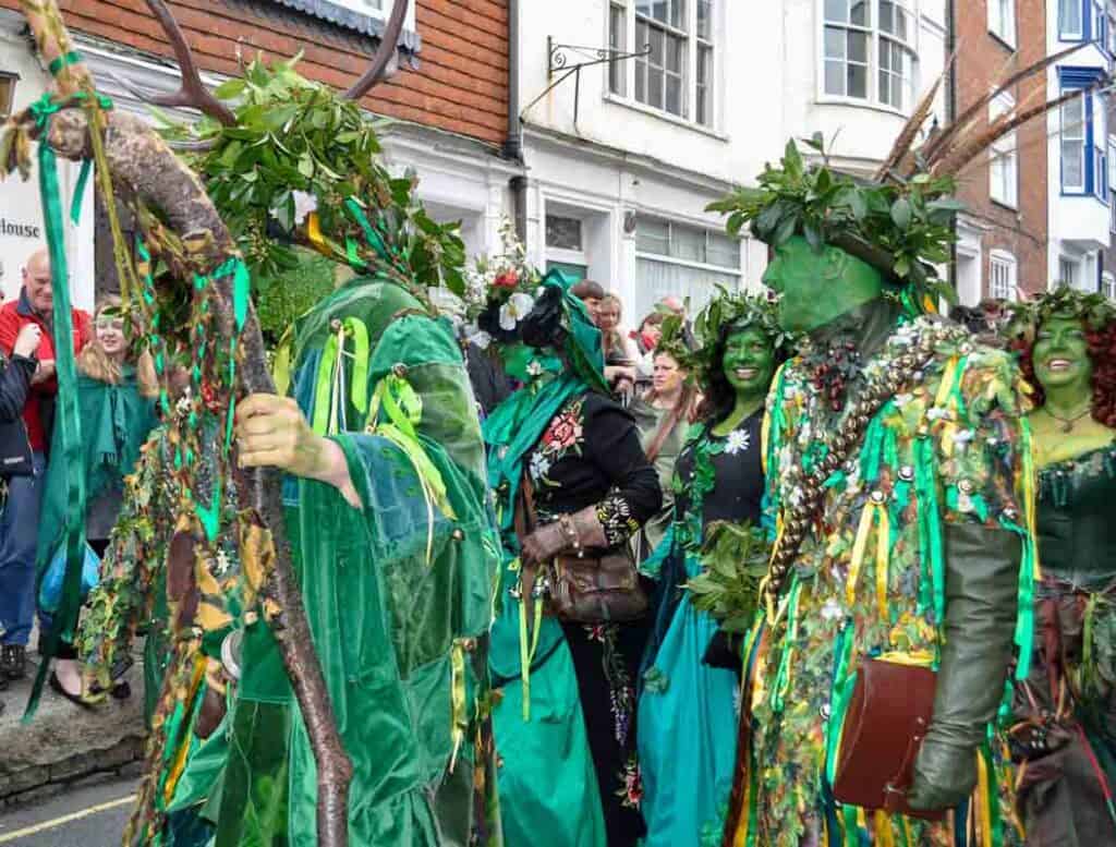 Men dressed in gree costumes with pheasant feathers in their hats for Jack in the Green Hastings