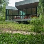 24 a modern, angular building with alluminium panels sitting within woodland at Goodwood Art Foundation