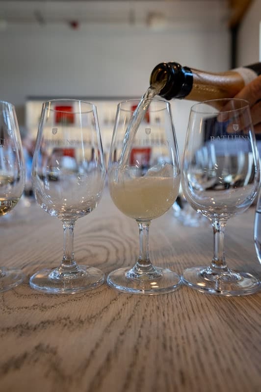 Sparkling wine from Sussex is poured into a glass at a winetasting